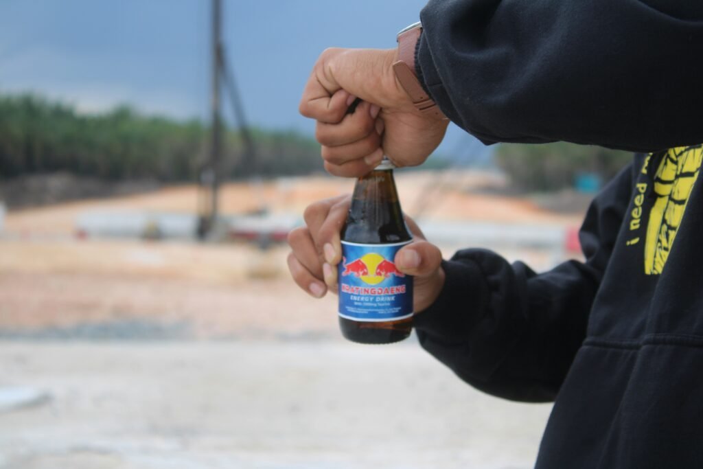 a man holding a bottle of beer in his hand